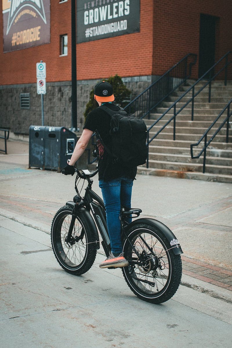 Young Man Riding Bicycle in the City