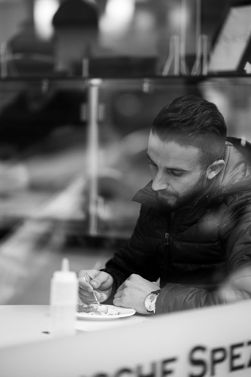 A woman dining alone, reflecting on societal views